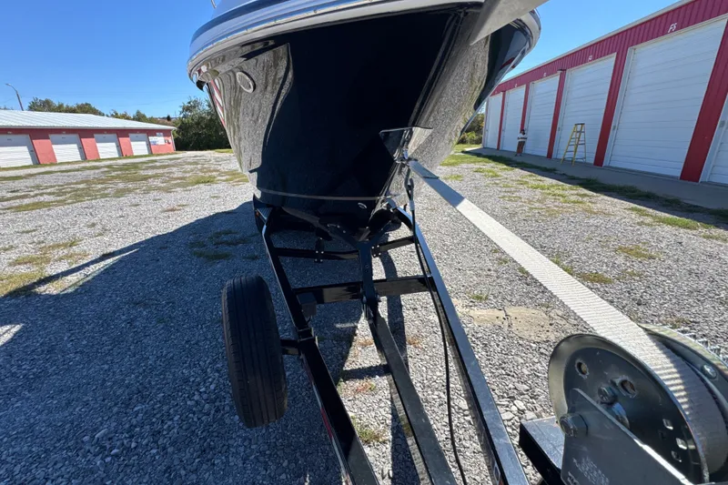 Slide: The Image of 2017 Regal 28 Express boat on trailer in storage facility. - 21