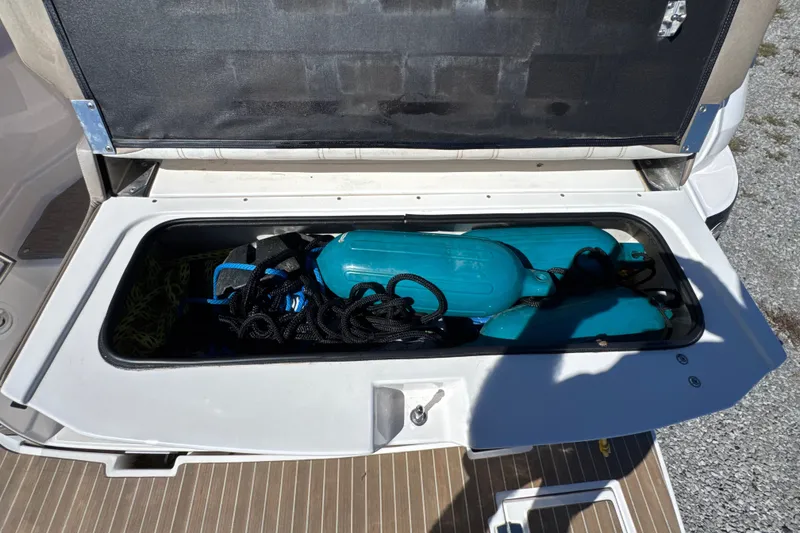 Slide: The Image of Storage compartment of 2017 Regal 28 Express boat with blue fenders and ropes. - 74