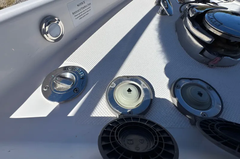 Slide: The Image of 2017 Regal 28 Express boat deck with water and fuel access points. - 57