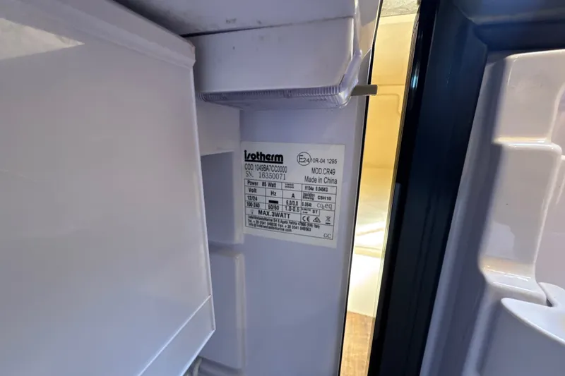 Slide: The Image of Label inside a refrigerator on a 2017 Regal 28 Express boat. - 91