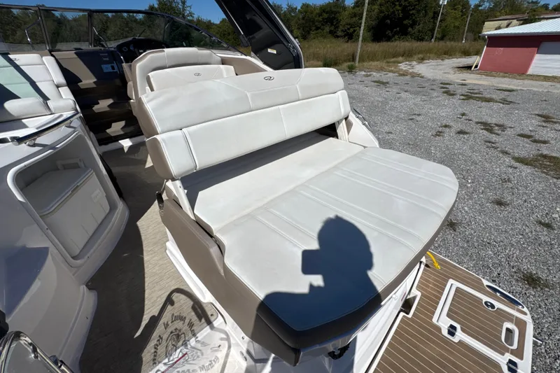 Slide: The Image of 2017 Regal 28 Express boat interior with white leather seating and dashboard view. - 32