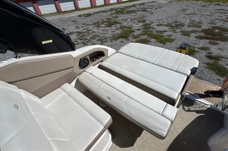Slide: The Image of 2017 Regal 28 Express boat interior with adjustable seating and beige upholstery. - 40