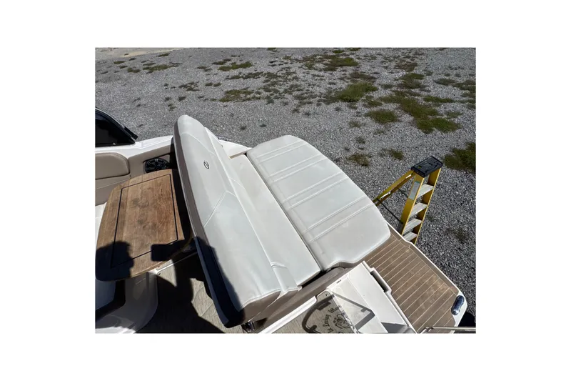 Slide: The Image of 2017 Regal 28 Express boat interior with white seating and wooden table. - 31