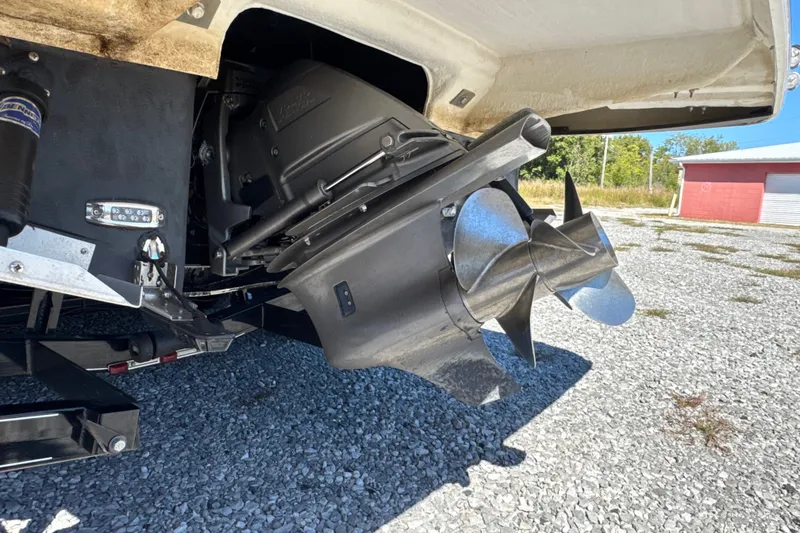 Slide: The Image of 2017 Regal 28 Express boat propeller and stern drive on gravel surface. - 7