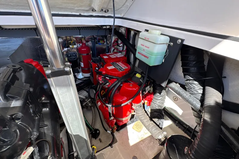 Slide: The Image of Engine compartment of a 2017 Regal 28 Express boat, featuring a red Westerbeke generator. - 68