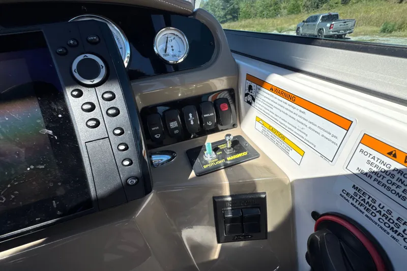 Slide: The Image of 2017 Regal 28 Express dashboard with controls, gauges, and warning labels. - 48