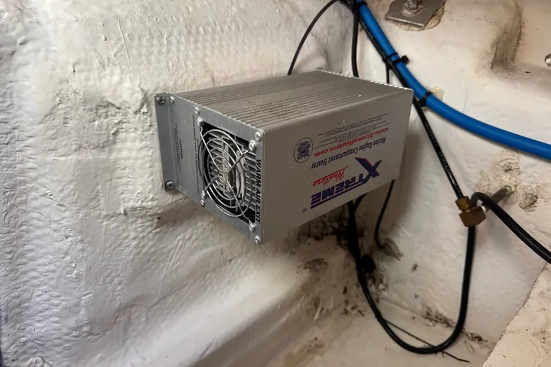 Slide: The Image of Engine compartment heater in a 2017 Regal 28 Express boat, mounted on a white surface. - 72