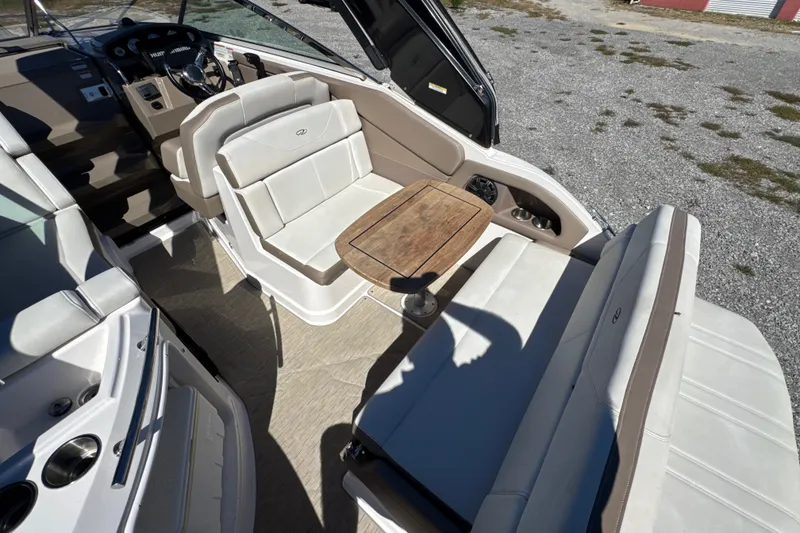 Slide: The Image of 2017 Regal 28 Express boat interior with seating and wooden table. - 29