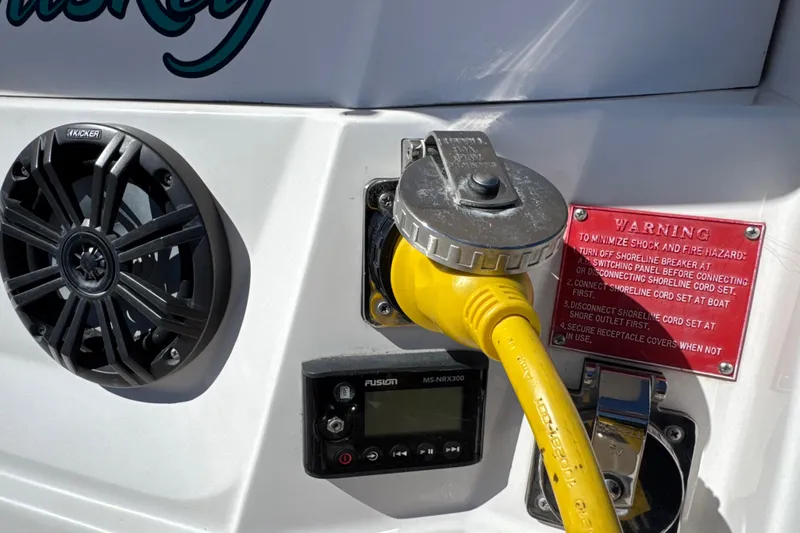 Slide: The Image of 2017 Regal 28 Express boat with speaker, power connection, and warning label. - 12