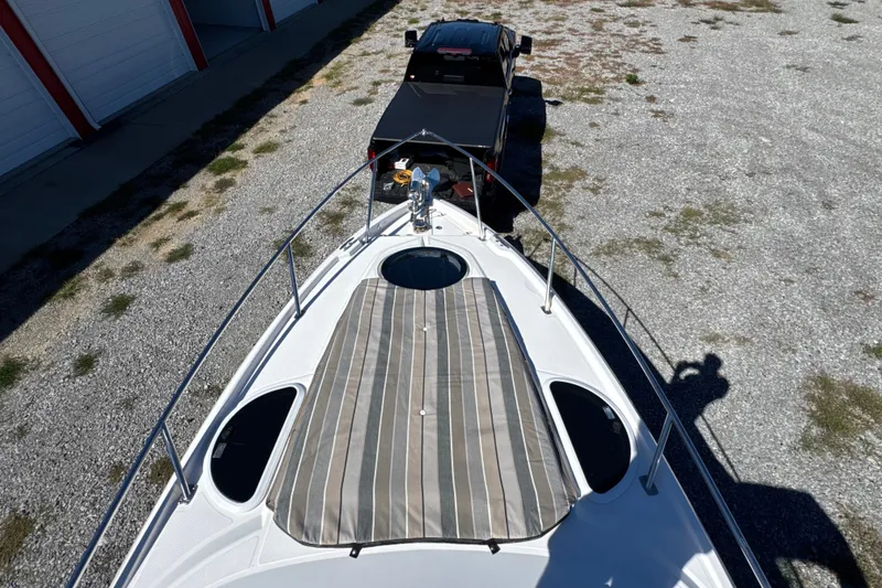 Slide: The Image of 2017 Regal 28 Express boat on trailer, top view, parked on gravel. - 52