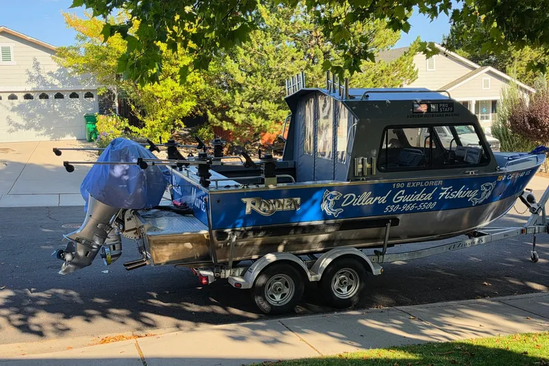 Slide: The Image of 2019 Raider 190 Explorer fishing boat on trailer in suburban neighborhood. - 1