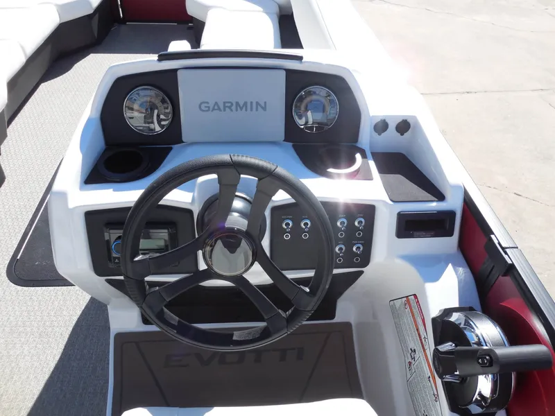 Slide: The Image of The image shows the helm of an Evotti 525CSA boat with a Garmin navigation system. - 26