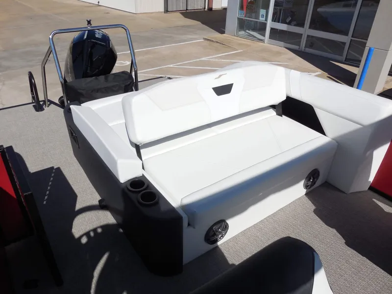 Slide: The Image of The image shows the cockpit of a 2027 Evotti 525CSA boat with white upholstery and cup holders. - 19