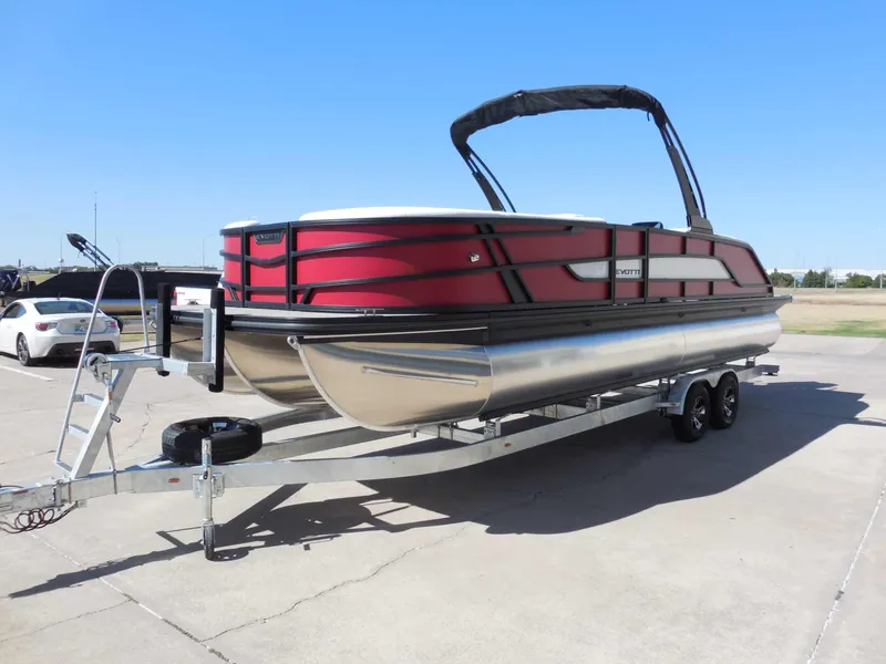 Slide: The Image of A red Evotti 525CSA pontoon boat from 2027 is on a trailer. - 8