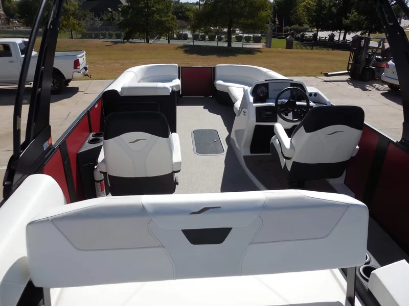 Slide: The Image of The image shows the interior of a 2027 Evotti 525CSA boat with white seating and a helm station. - 24
