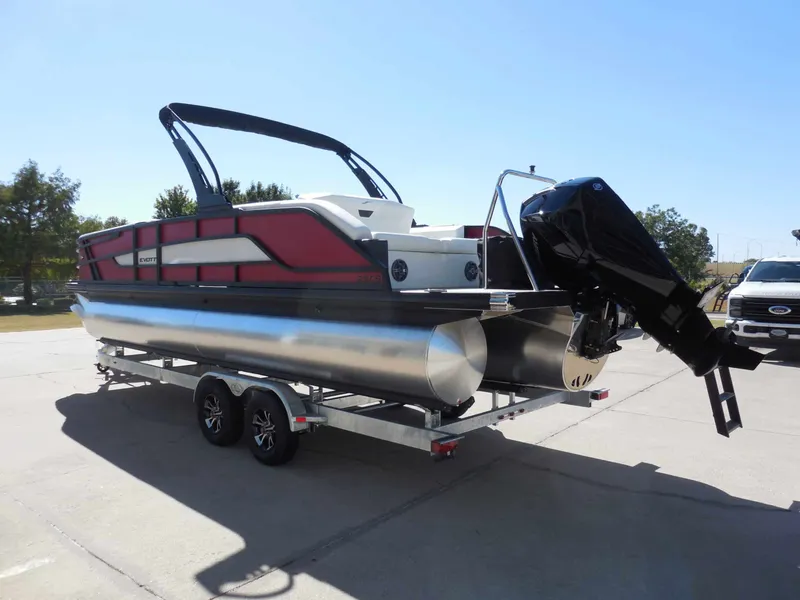 Slide: The Image of A modern pontoon boat with red and black design, on a trailer with an outboard motor. - 6