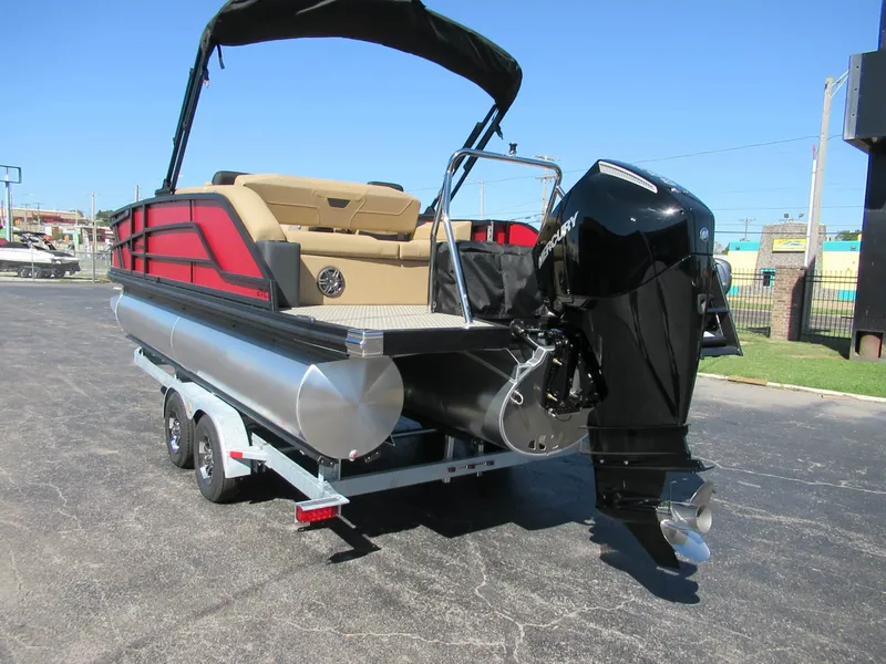 Slide: The Image of The image shows an Evotti 521CS pontoon boat from 2027 on a trailer. It features a black outboard motor and red accents. - 3