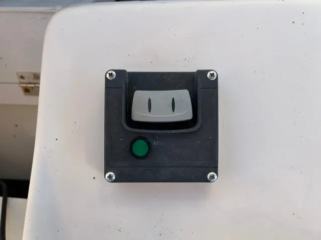 Slide: The Image of Close-up of a switch on a boat, surrounded by a white surface. - 27
