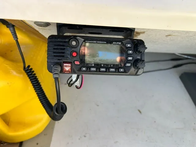 Slide: The Image of A radio is mounted under a white boat canopy. It features several knobs and a display. - 29
