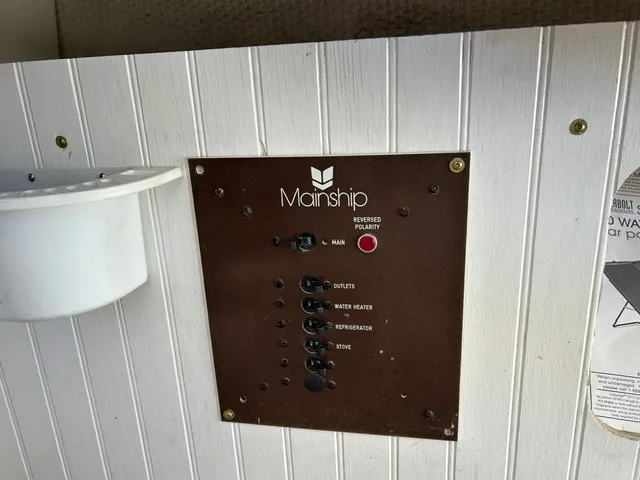 Slide: The Image of An electrical panel on a 1979 Mainship 34 Trawler with multiple switches. - 14
