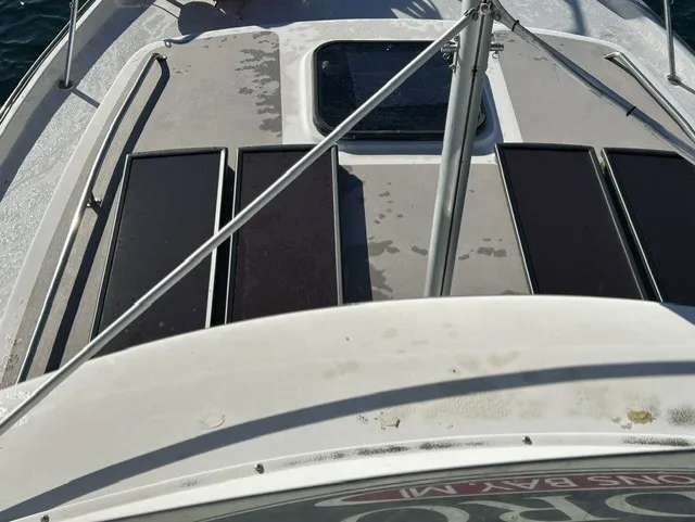 Slide: The Image of The image shows the deck of a 1979 Mainship 34 Trawler with solar panels. - 32