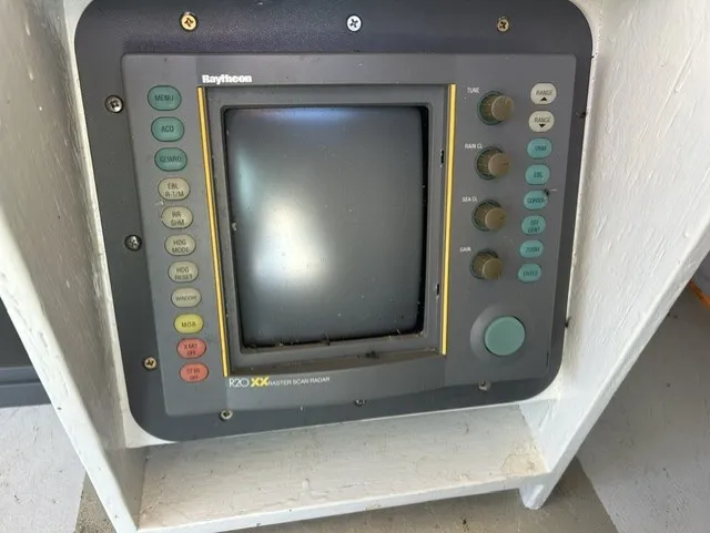 Slide: The Image of A Raytheon radar screen with various buttons and a large display. - 30