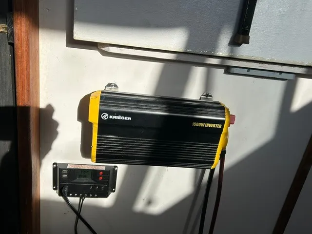 Slide: The Image of A Krieger 1500W inverter is mounted on the wall of a 1979 Mainship 34 Trawler. - 13