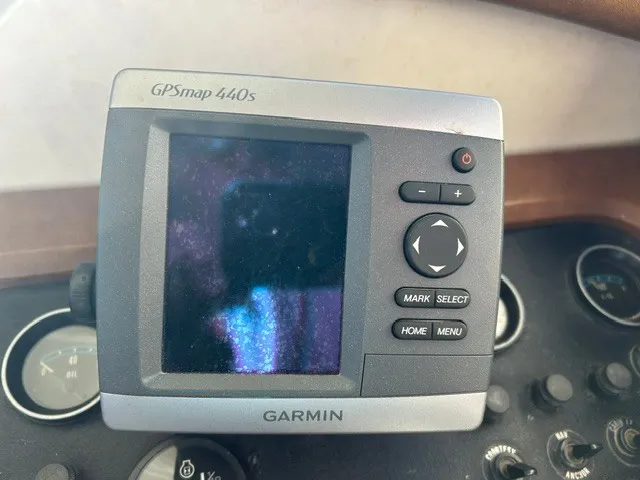 Slide: The Image of A Garmin GPSmap 440s device is mounted on a boat, surrounded by various instruments. - 24