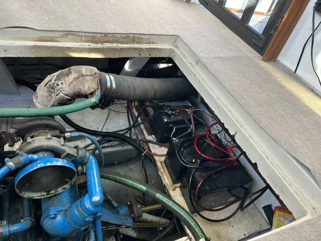 Slide: The Image of The engine compartment of a 1979 Mainship 34 Trawler showing engine and battery components. - 34