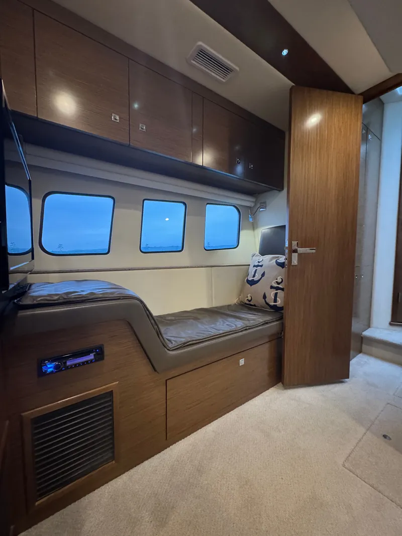 Slide: The Image of Interior of a 2013 Cruisers Yachts 45 Cantius with wood furnishings and windows. - 48