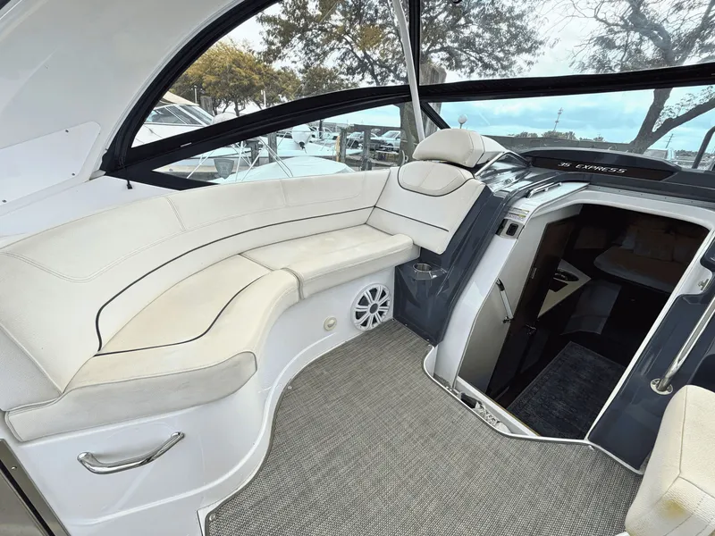 Slide: The Image of The image shows the cockpit of a 2018 Cruisers Yachts 35 Express with beige seating and a helm station. - 11