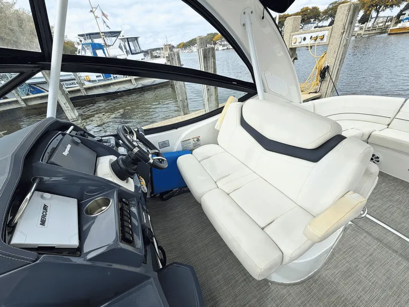 Slide: The Image of The image shows the cockpit of a 2018 Cruisers Yachts 35 Express with white seating and a helm station. - 12