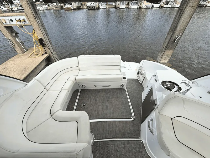 Slide: The Image of The image shows the cockpit of a 2018 Cruisers Yachts 35 Express with white upholstery and gray carpet. - 5