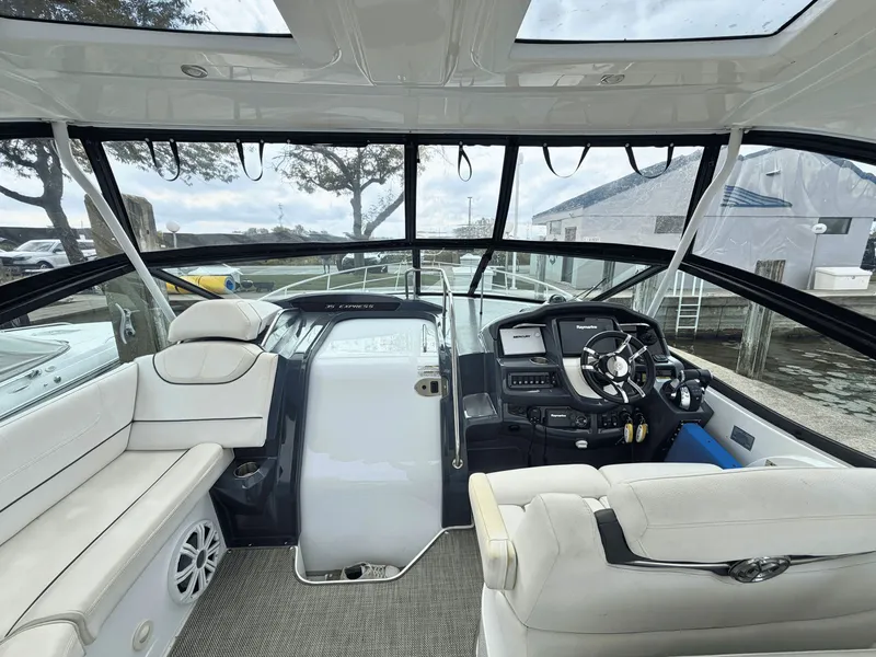 Slide: The Image of The image shows the cockpit of a 2018 Cruisers Yachts 35 Express with white seating and a modern helm. - 4