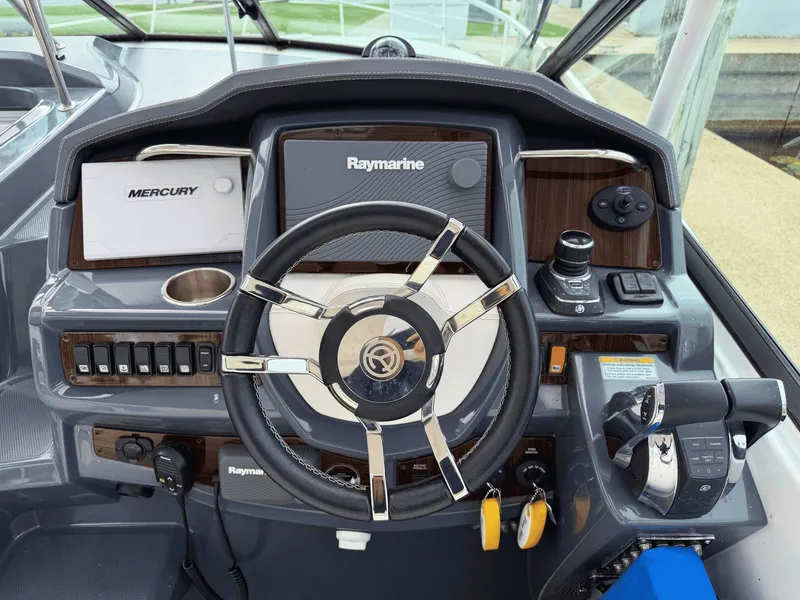 Slide: The Image of The image shows the helm of a 2018 Cruisers Yachts 35 Express with modern instruments. - 13