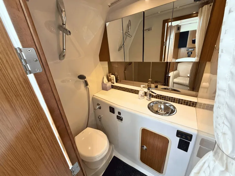 Slide: The Image of The image shows a sleek yacht bathroom with a sink, toilet, and mirror. - 21