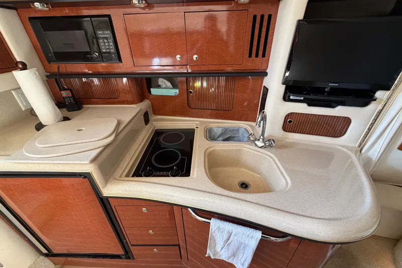 Slide: The Image of Interior of 2002 Sea Ray 340 Sundancer yacht kitchen with sink, stove, and microwave. - 41