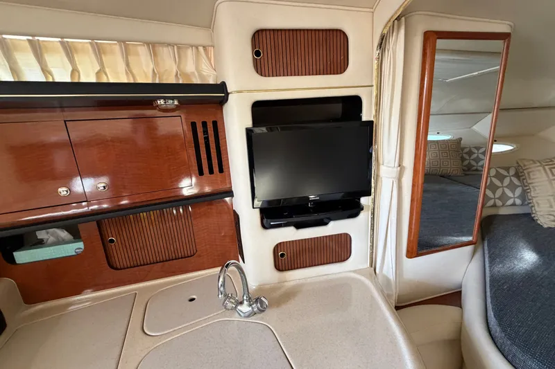Slide: The Image of Interior of 2002 Sea Ray 340 Sundancer with TV, cabinets, and cozy seating area. - 42