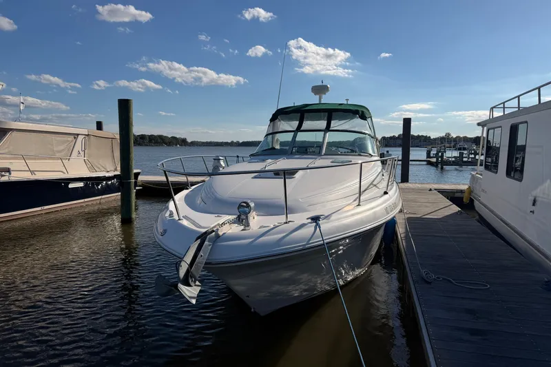 The Image of 2002 Sea Ray 340 Sundancer docked at marina under clear blue sky. - 0