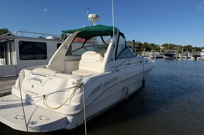 Slide: The Image of 2002 Sea Ray 340 Sundancer yacht docked at marina, clear sky, calm water. - 3