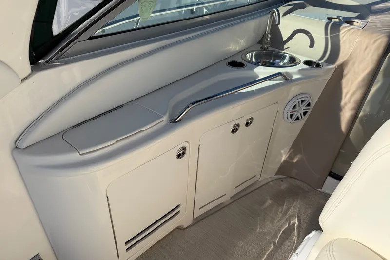 Slide: The Image of Interior view of a 2002 Sea Ray 340 Sundancer boat with a compact sink and storage area. - 14