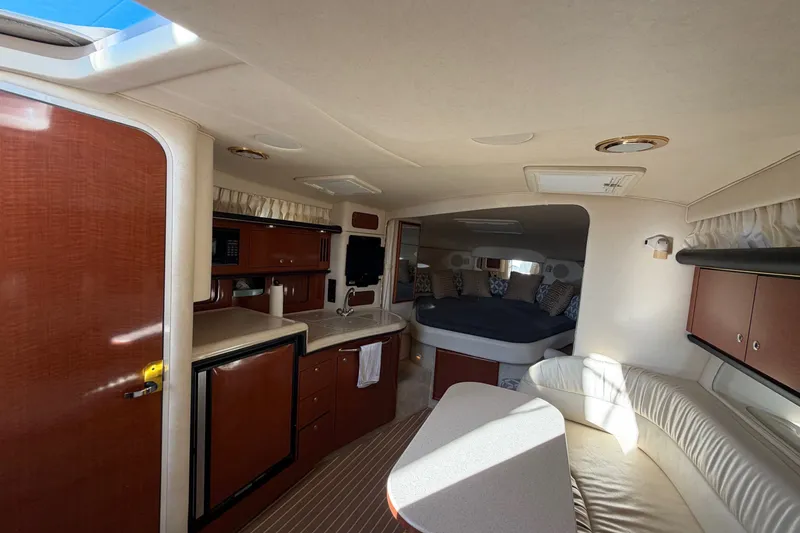 Slide: The Image of Interior of 2002 Sea Ray 340 Sundancer yacht with cozy seating and kitchenette. - 33