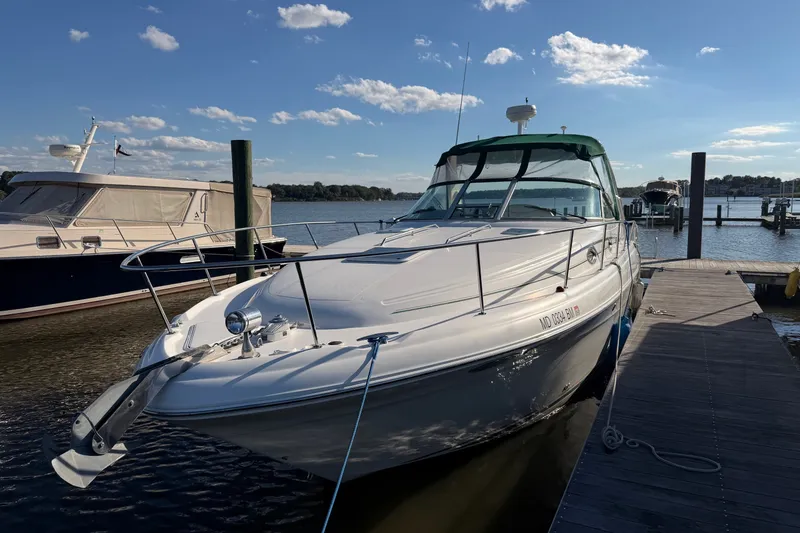 Slide: The Image of 2002 Sea Ray 340 Sundancer docked at marina under clear blue sky. - 1