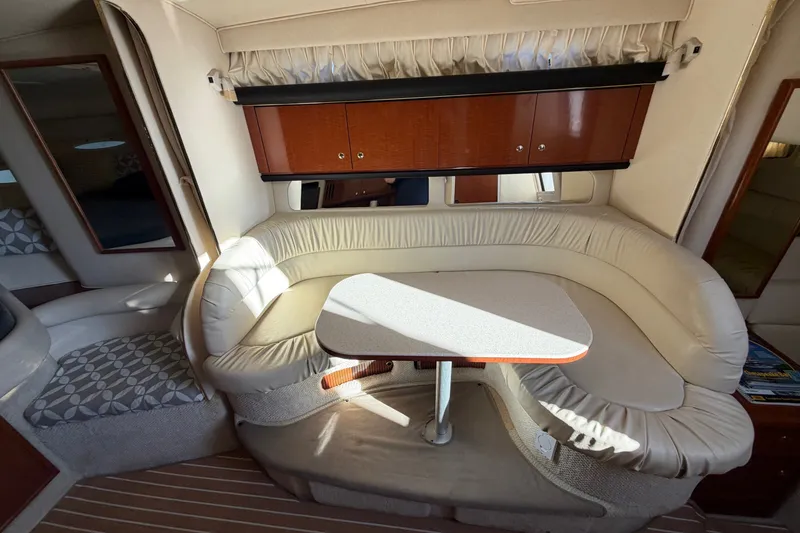 Slide: The Image of Interior of 2002 Sea Ray 340 Sundancer with cozy seating and wooden cabinetry. - 30