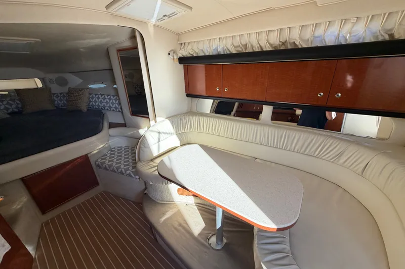 Slide: The Image of Interior of 2002 Sea Ray 340 Sundancer yacht with cozy seating and wooden cabinetry. - 31