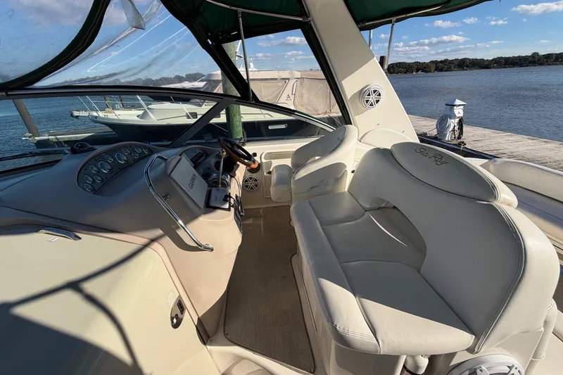 Slide: The Image of Interior view of 2002 Sea Ray 340 Sundancer yacht with white seating and dashboard. - 19