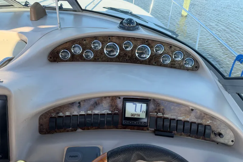 Slide: The Image of Dashboard of a 2002 Sea Ray 340 Sundancer boat with gauges and depth display. - 16