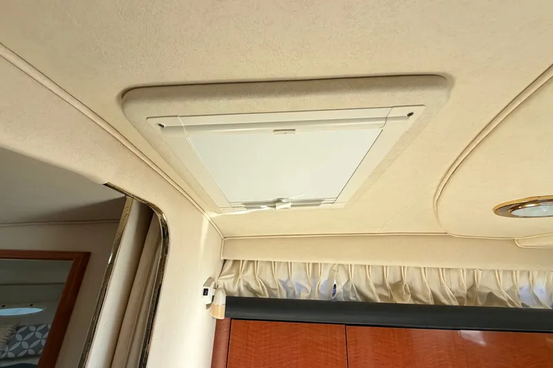 Slide: The Image of Ceiling hatch inside 2002 Sea Ray 340 Sundancer boat cabin, featuring beige interior design. - 48