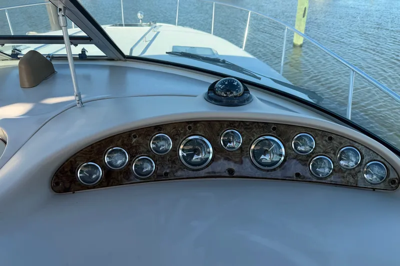 Slide: The Image of Dashboard of a 2002 Sea Ray 340 Sundancer boat with gauges and compass. - 17