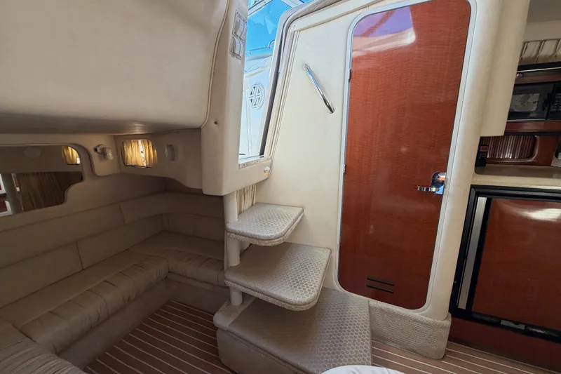 Slide: The Image of Interior of 2002 Sea Ray 340 Sundancer yacht with cozy seating and elegant wood finishes. - 38